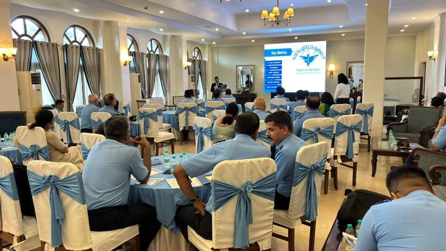 Presentation screen showing key figures while officers listen from their tables