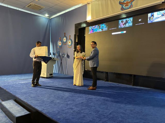 A memento being presented on stage at the close of the programme